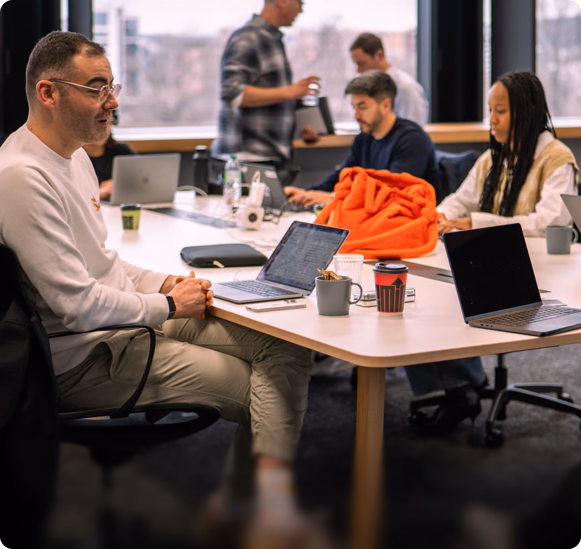 Team working on laptops around a shared table