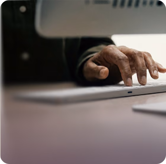 Hand typing on a laptop
