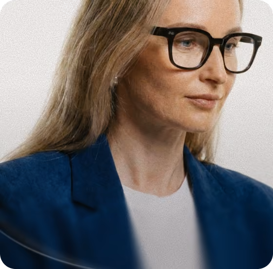 Woman with glasses looking at a screen