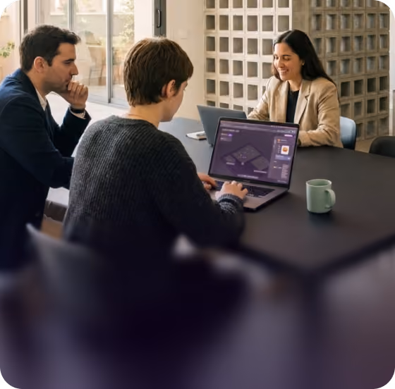 Business team building an automation together on a laptop