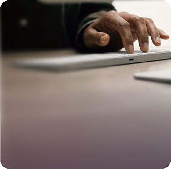 Hand typing on a laptop