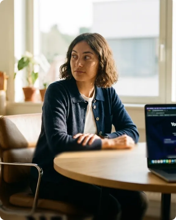 Customer care agent at a desk with a laptop