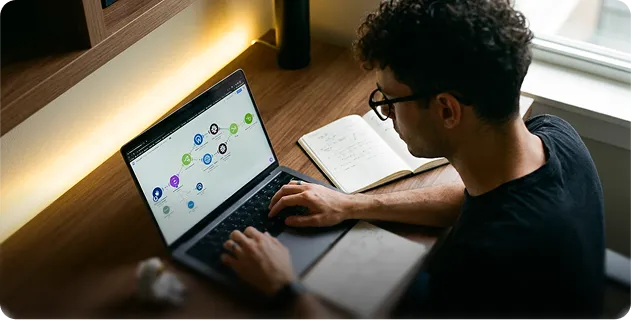 IT specialist building a Make scenario on a laptop