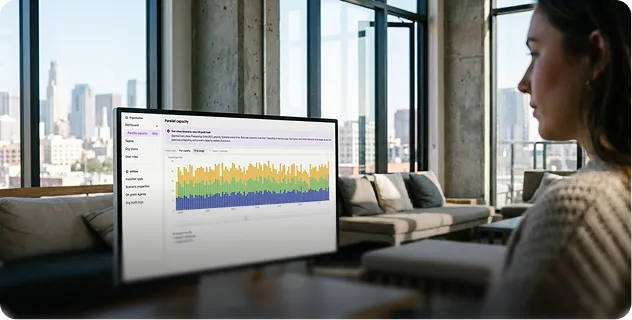 Sales rep looking at a sales chart on a monitor