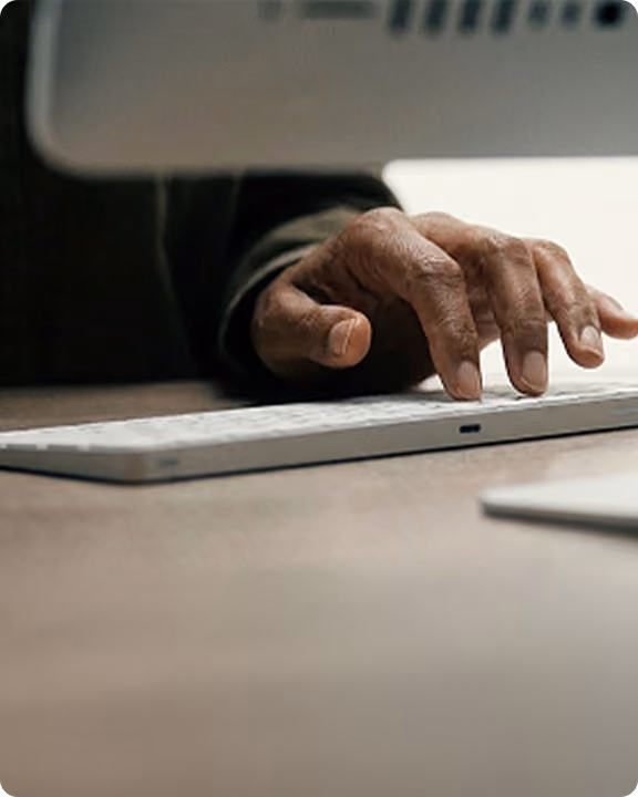 Hand typing on a laptop