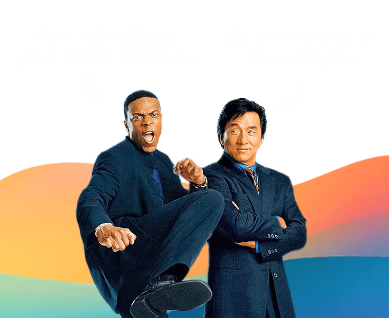 Two men in suits, one raising a leg aggressively while the other smiles with arms crossed.