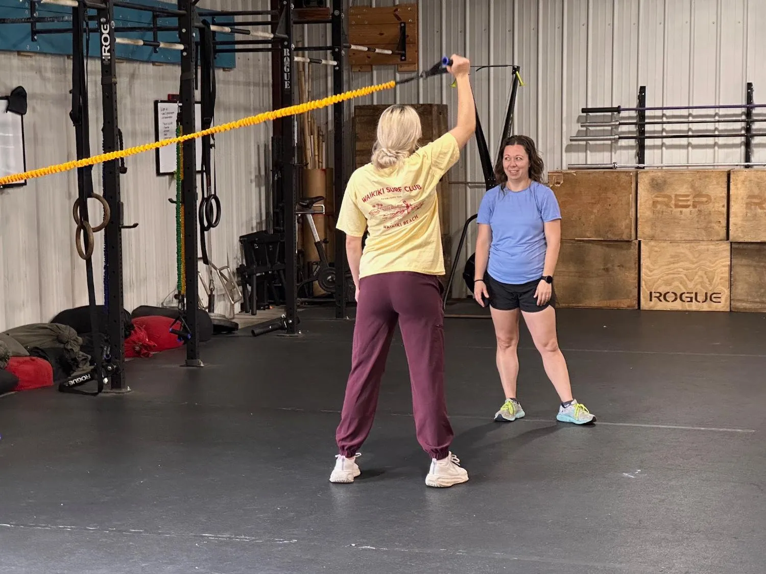 Physical therapist coaching a client through a resistance band exercise at Proactive Kinetics.