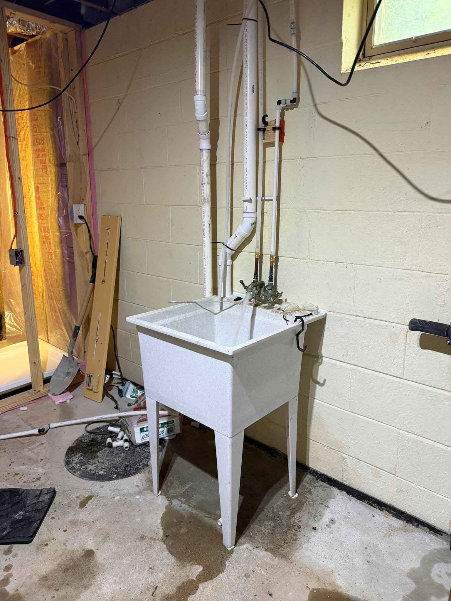 Utility sink with exposed water supply and drain lines