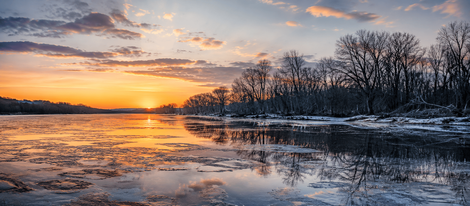 Frozen Minnesota lake at sunset during spring thaw season