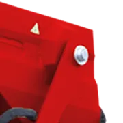 Close-up of a red metal machine part with a bolt and a warning triangle.