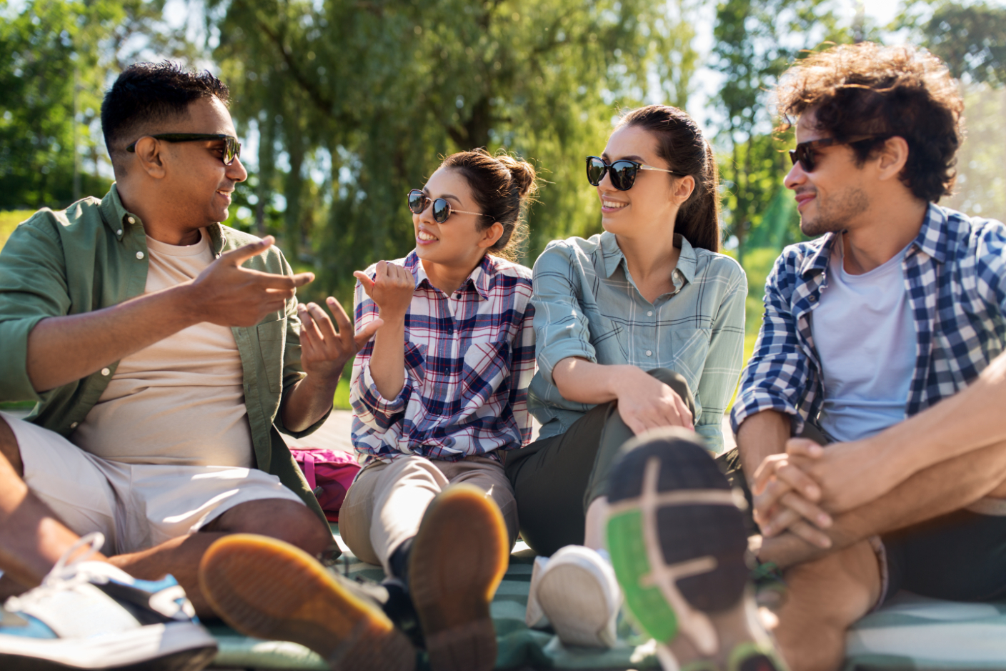 People gathered outdoors in grass chatting stock image