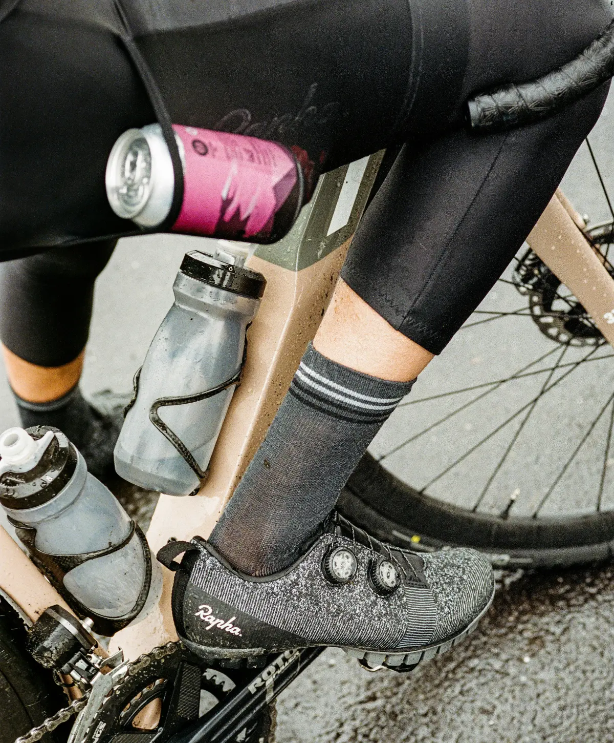 A bicycle with a water bottle and a can of energy drink.