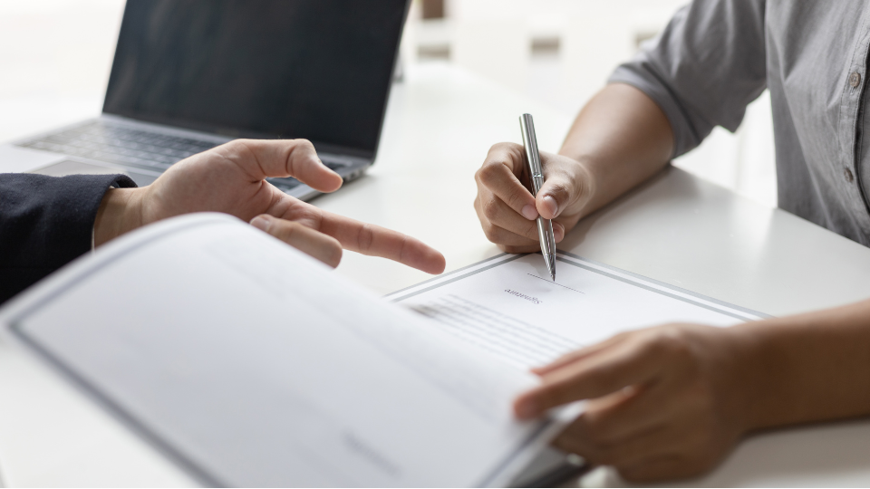 Alt text: Two people negotiating contract terms