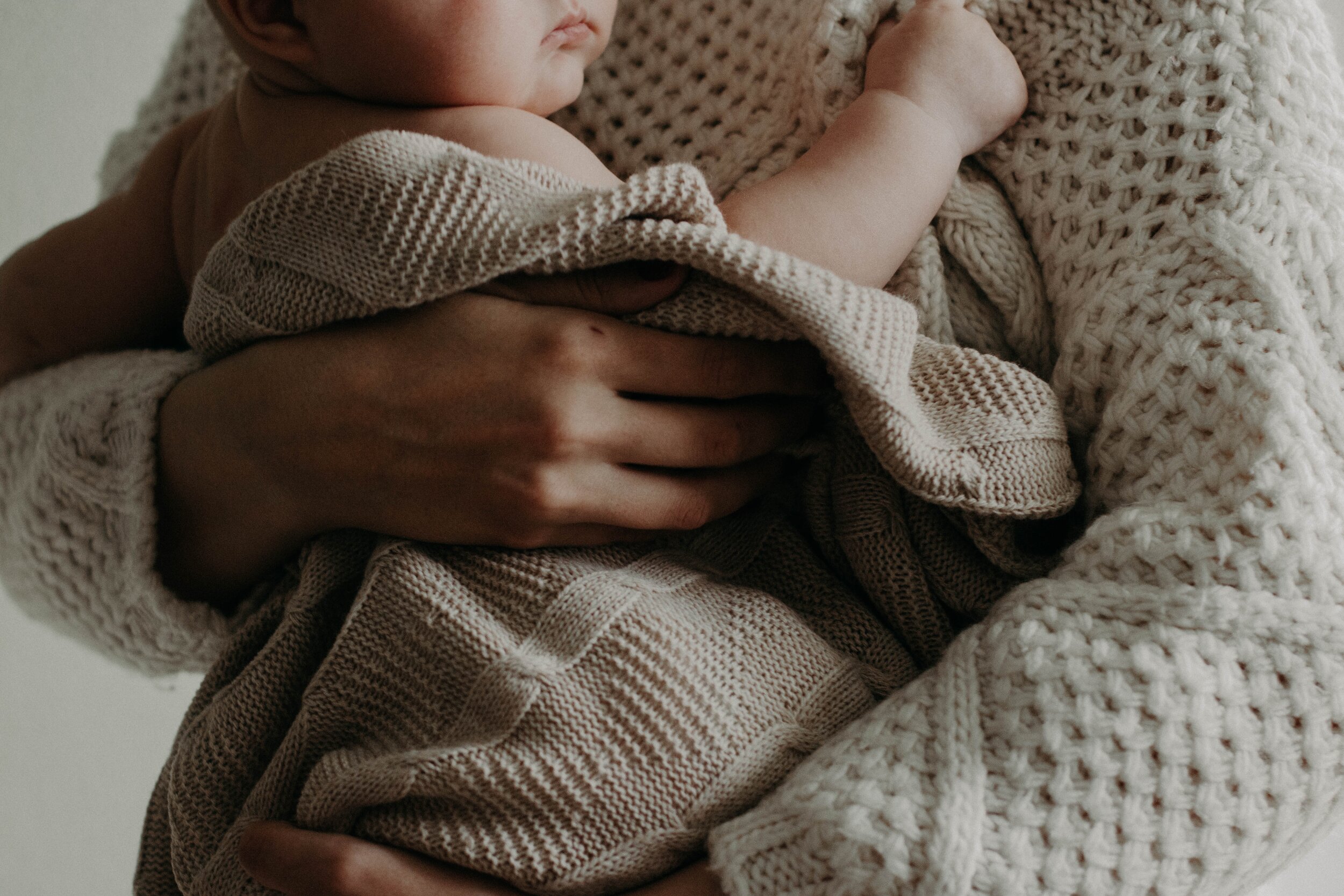 Baby is cradled in a warm knit blanket