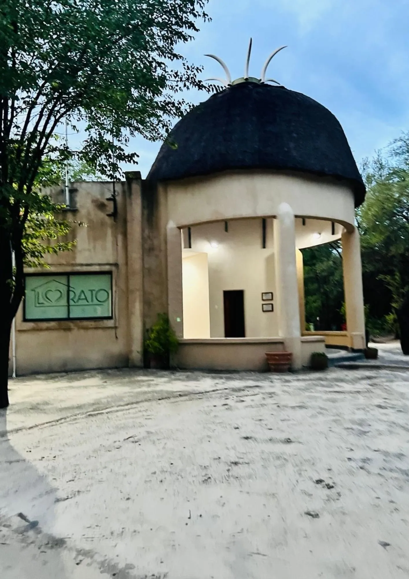 The thatched entrance of Lorato House Rescue Centre at dusk