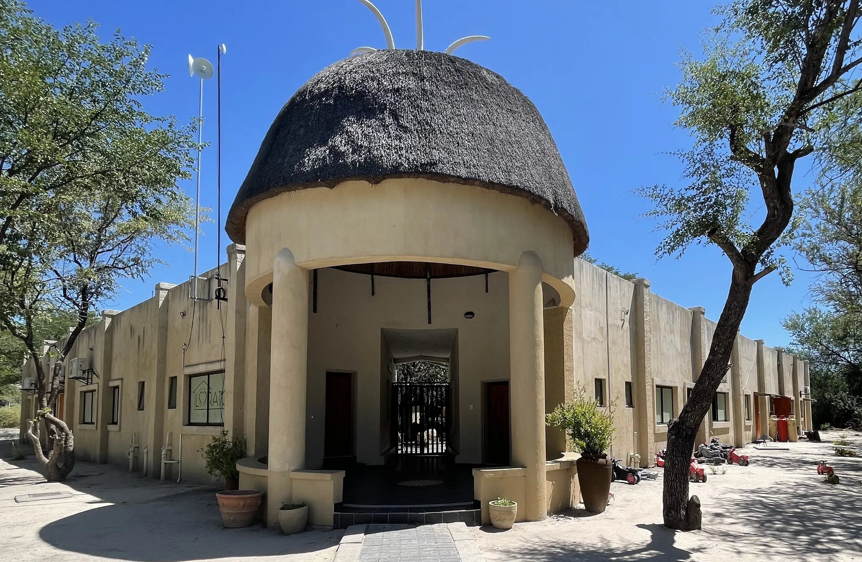 The thatched entrance of Lorato House Rescue Centre in Maun, Botswana
