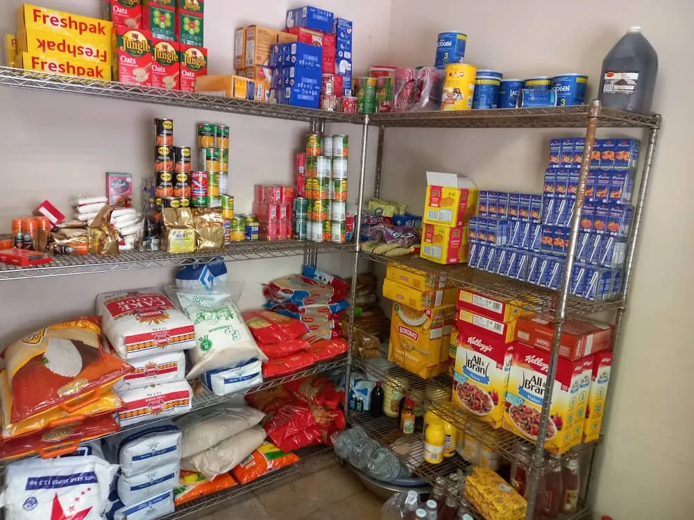 Shelves of food and household supplies in the Lorato House store