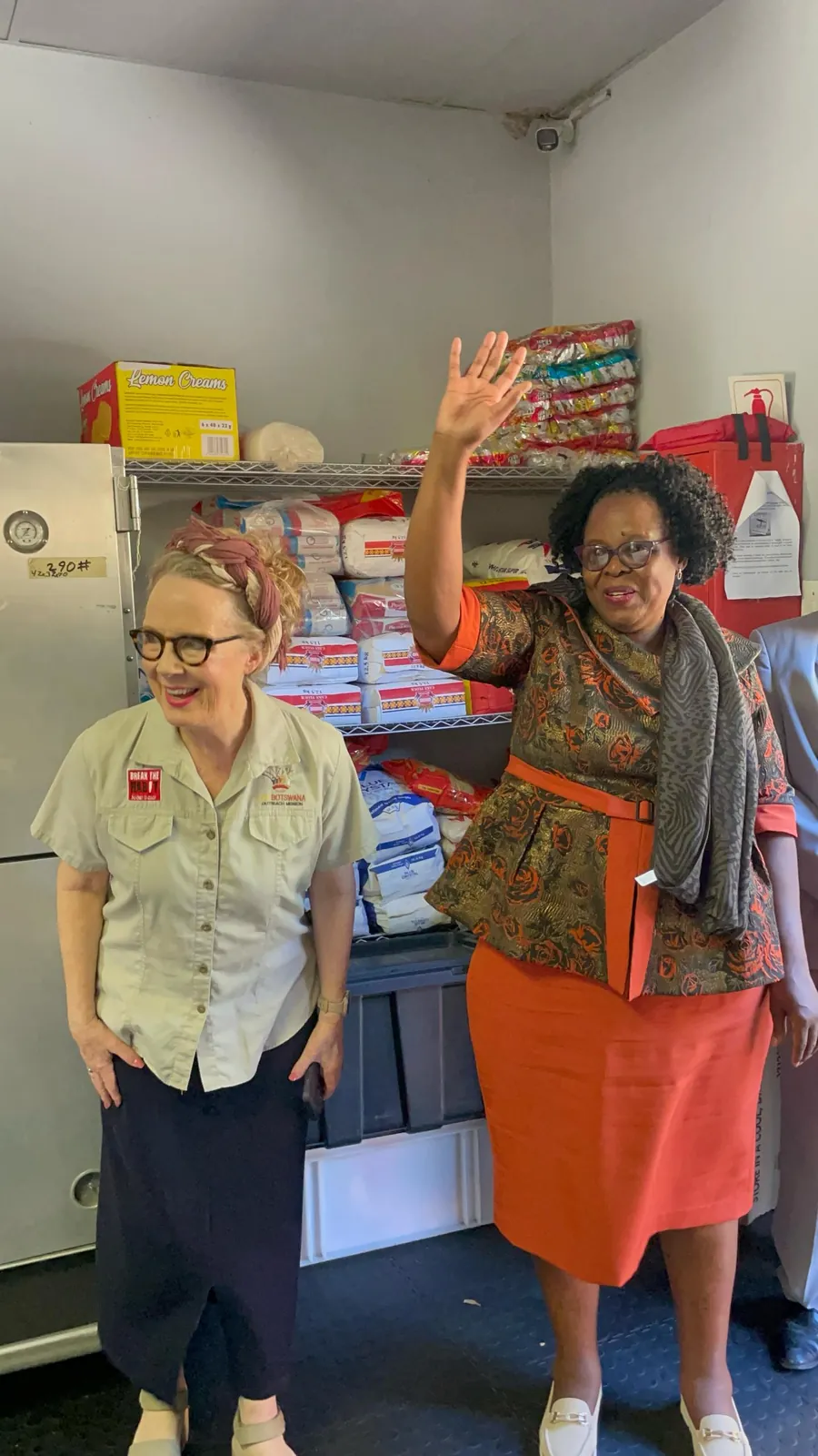 Two Lorato House team members in the supplies store room