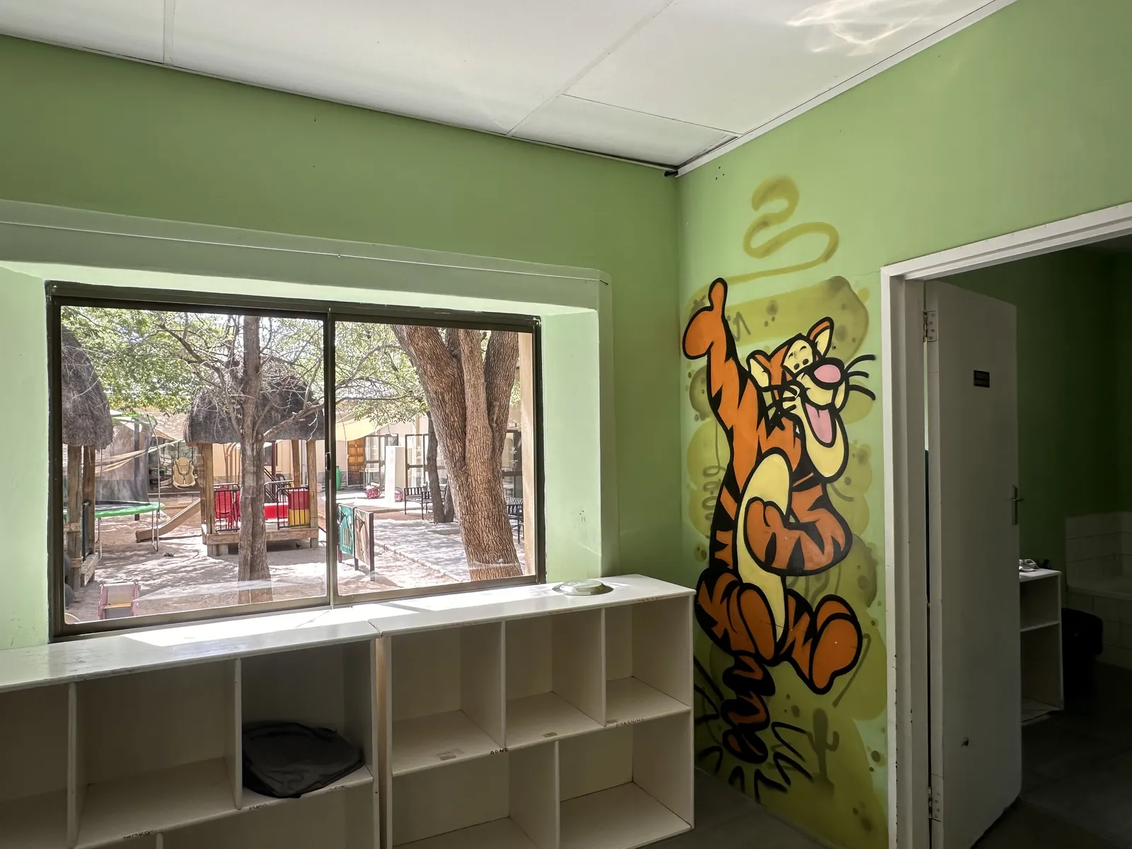 A room at Lorato House with a tiger mural beside the window