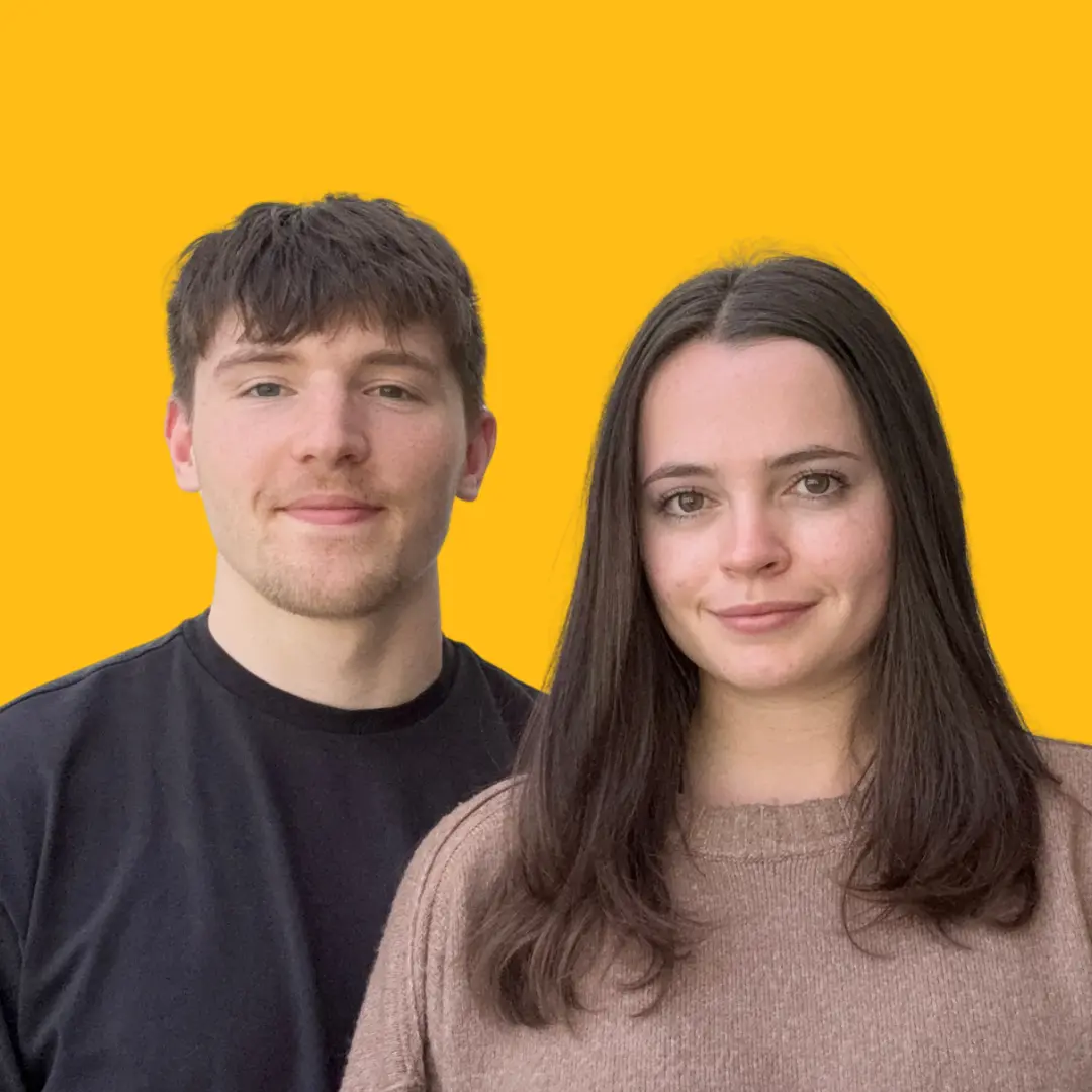 Portrait of Josh and Daizee against a bright yellow background.