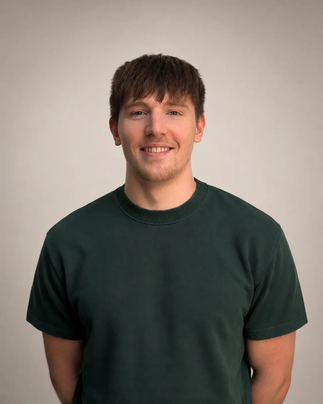 Josh wearing a dark green t-shirt against a plain light background.