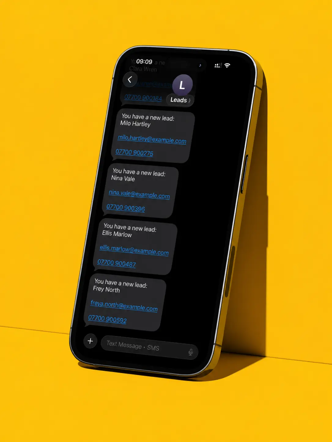 Smartphone on yellow surface displaying text messages with new lead contact details.