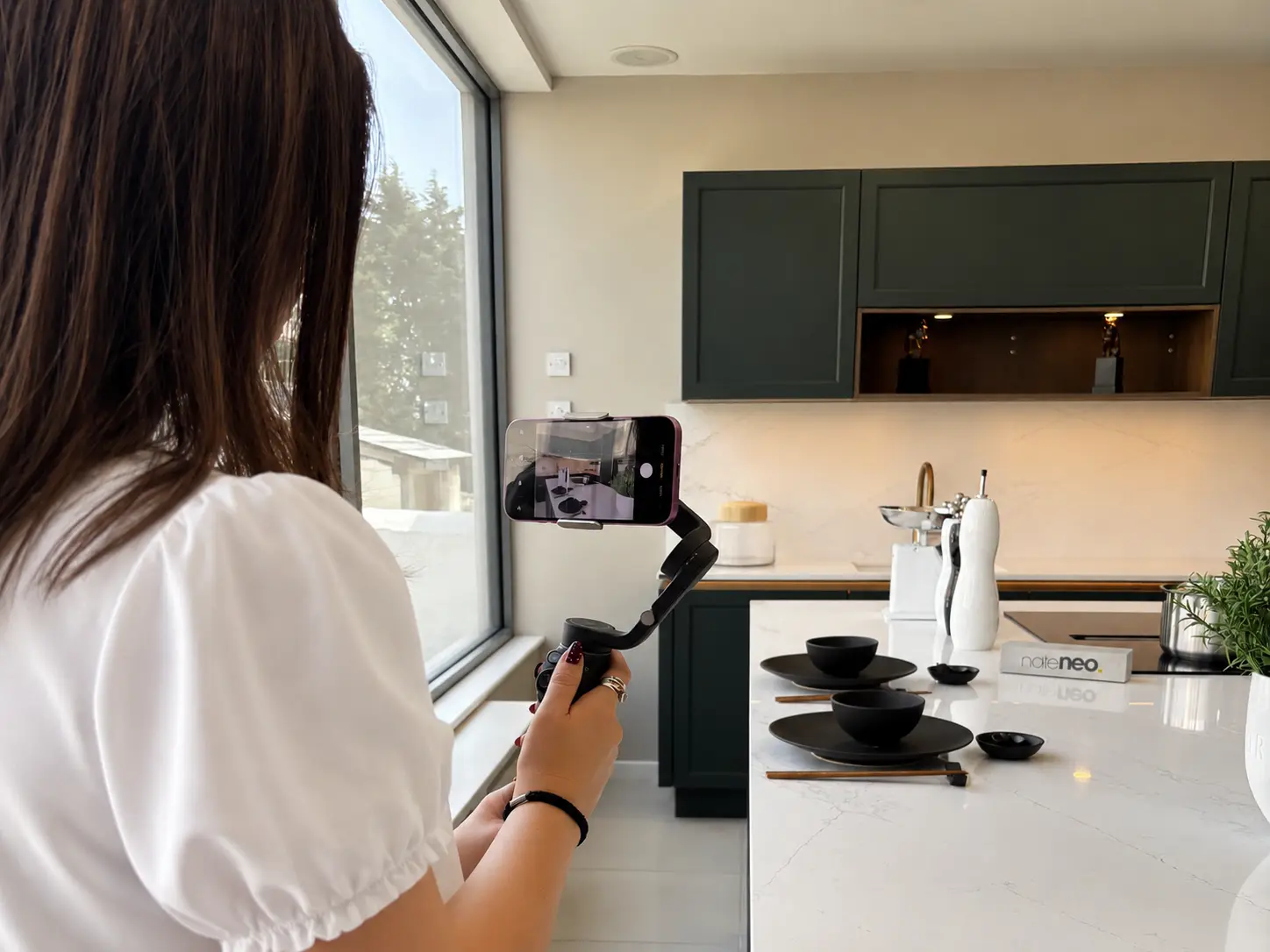 Daizee taking photos of a new Nolte Neo kitchen display at Platinum Interiors showroom