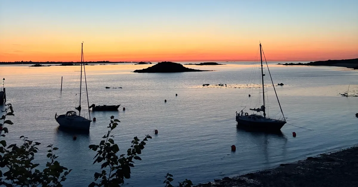 Guernsey beach with sun setting in the background