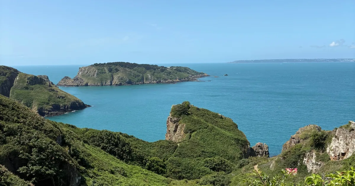 Coastal view of sark island with Guernsey and herm in the background