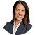 Smiling woman with shoulder-length brown hair wearing a dark blazer and light blouse.