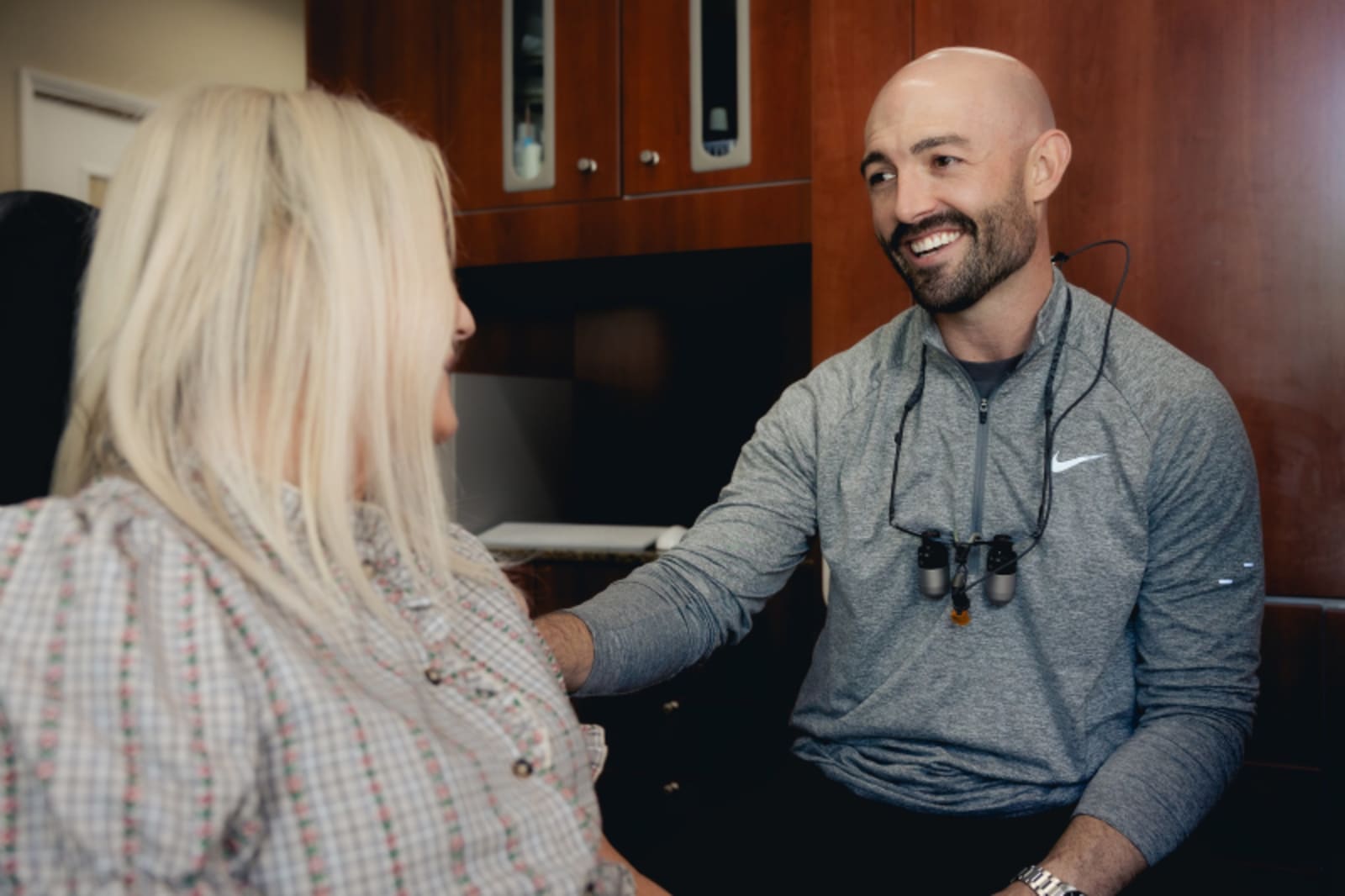 Dentist consulting with patient in welcoming treatment room