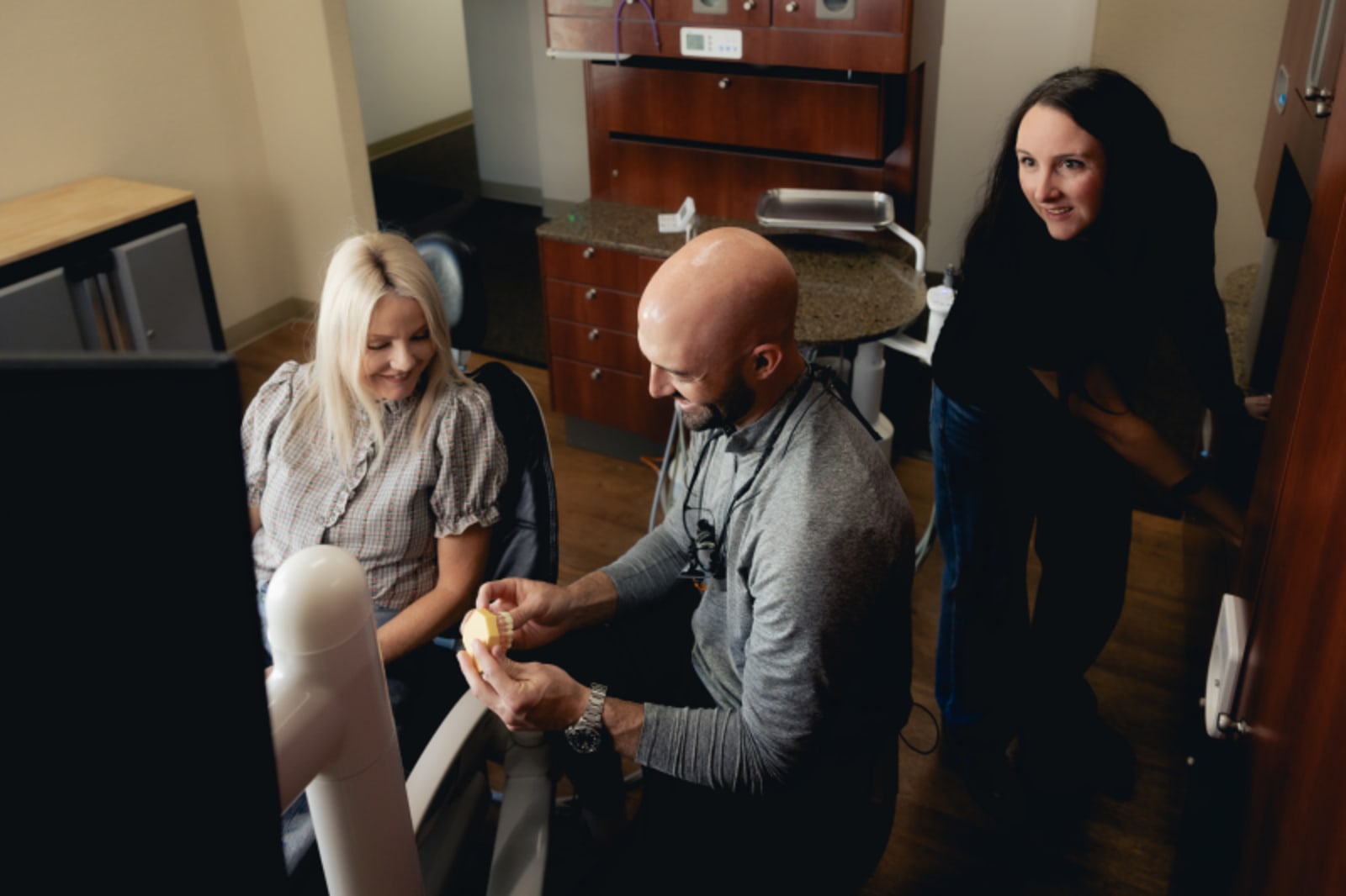 Dentist discussing treatment plan with female patient in Pacific Rim Dental office.
