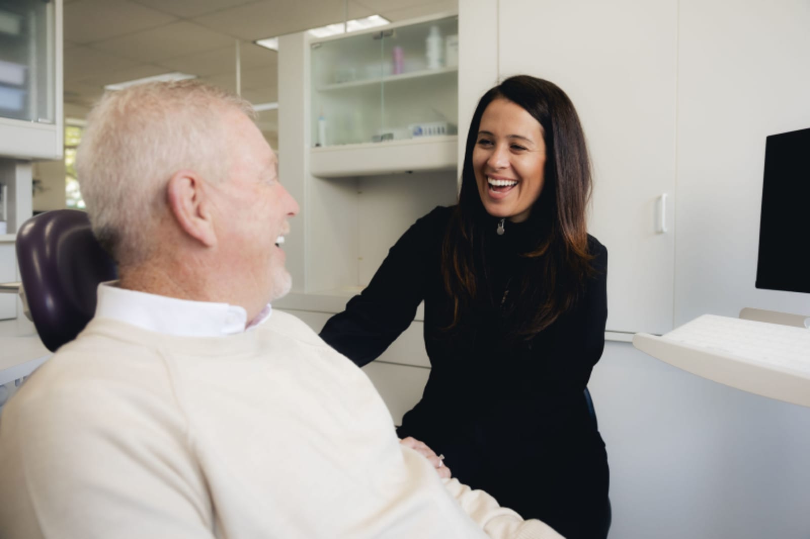 Dentist explaining treatment plan to patient in clinical setting