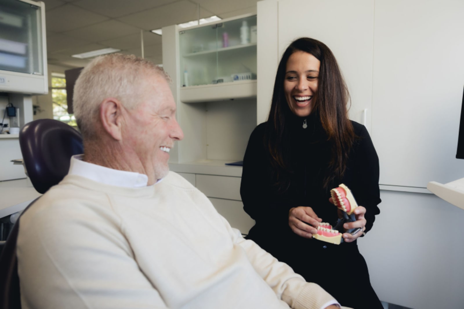 Dental professional consulting with patient in clinical setting