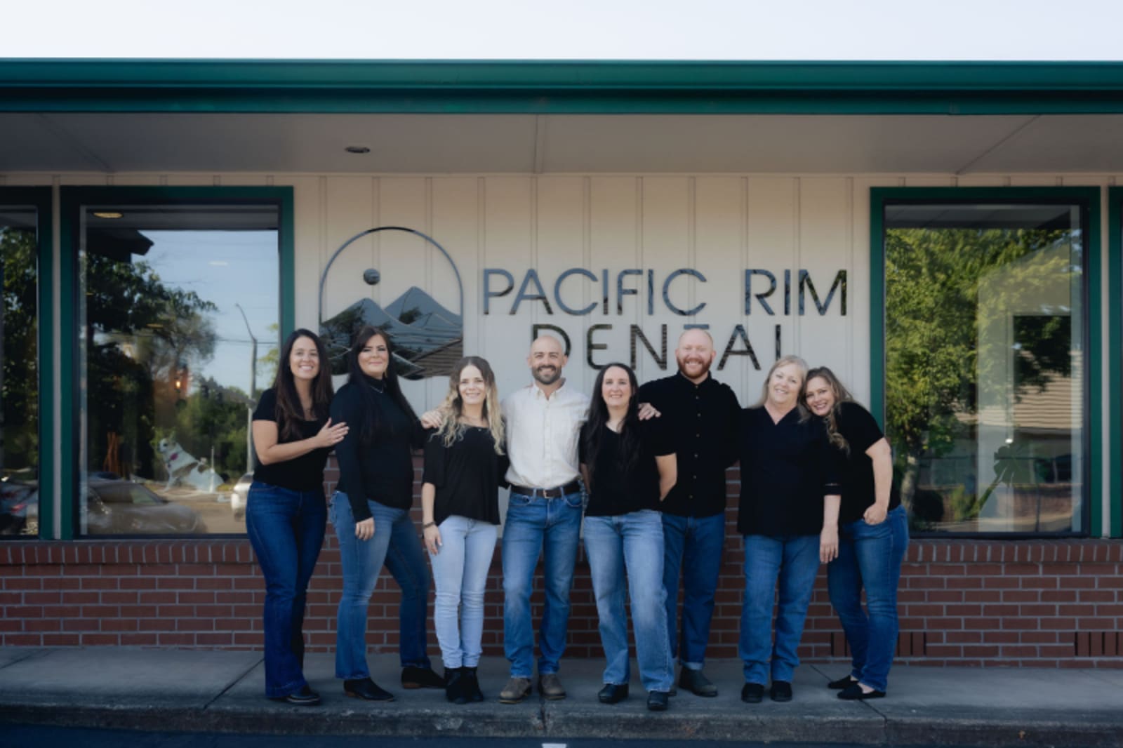 Pacific Rim Dental team standing together outside practice entrance
