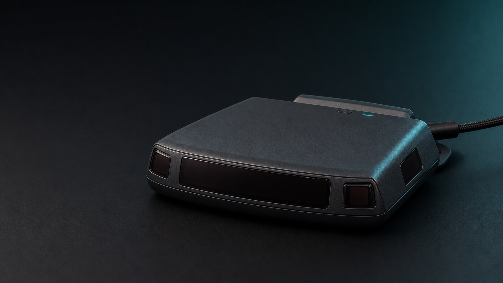 Matte-graphite BanditKin Sentinel roadside-awareness receiver with a wide dark front sensor panel, four small optical receiver windows, windshield cradle, and USB-C cable. Product render.