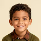 Smiling young boy with curly hair wearing a brown shirt.