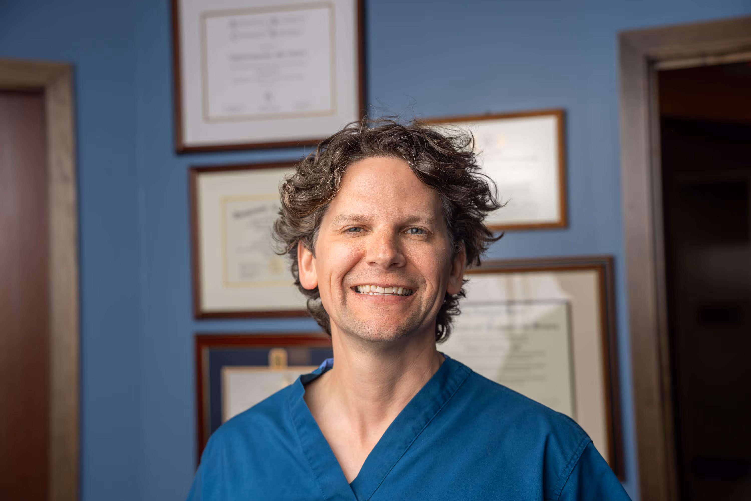 Dr. Schneider examines a patient's chin and neck contour during a complimentary consultation at Riverview in St. Paul