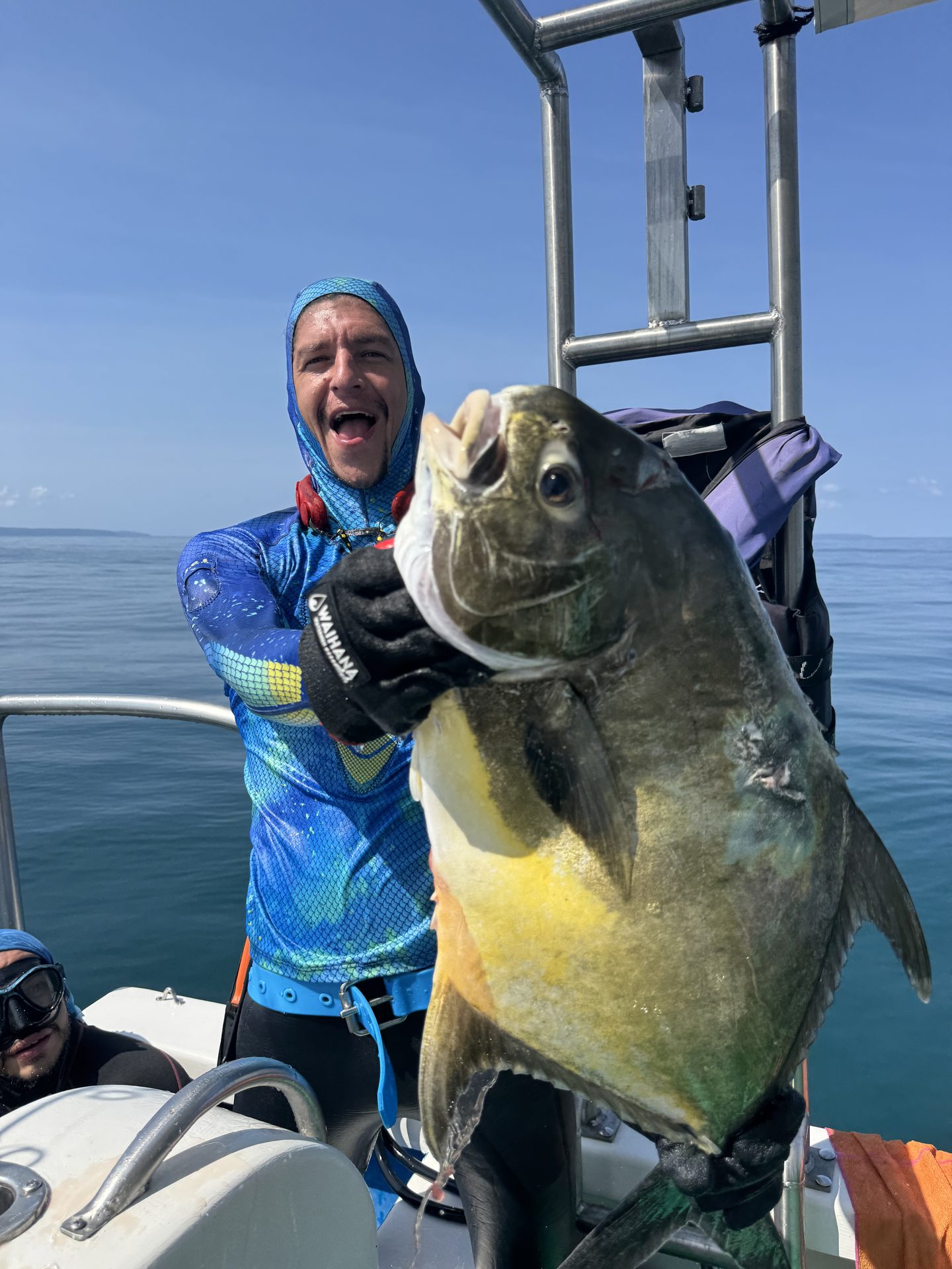 A spearfisher on the boat with a large catch