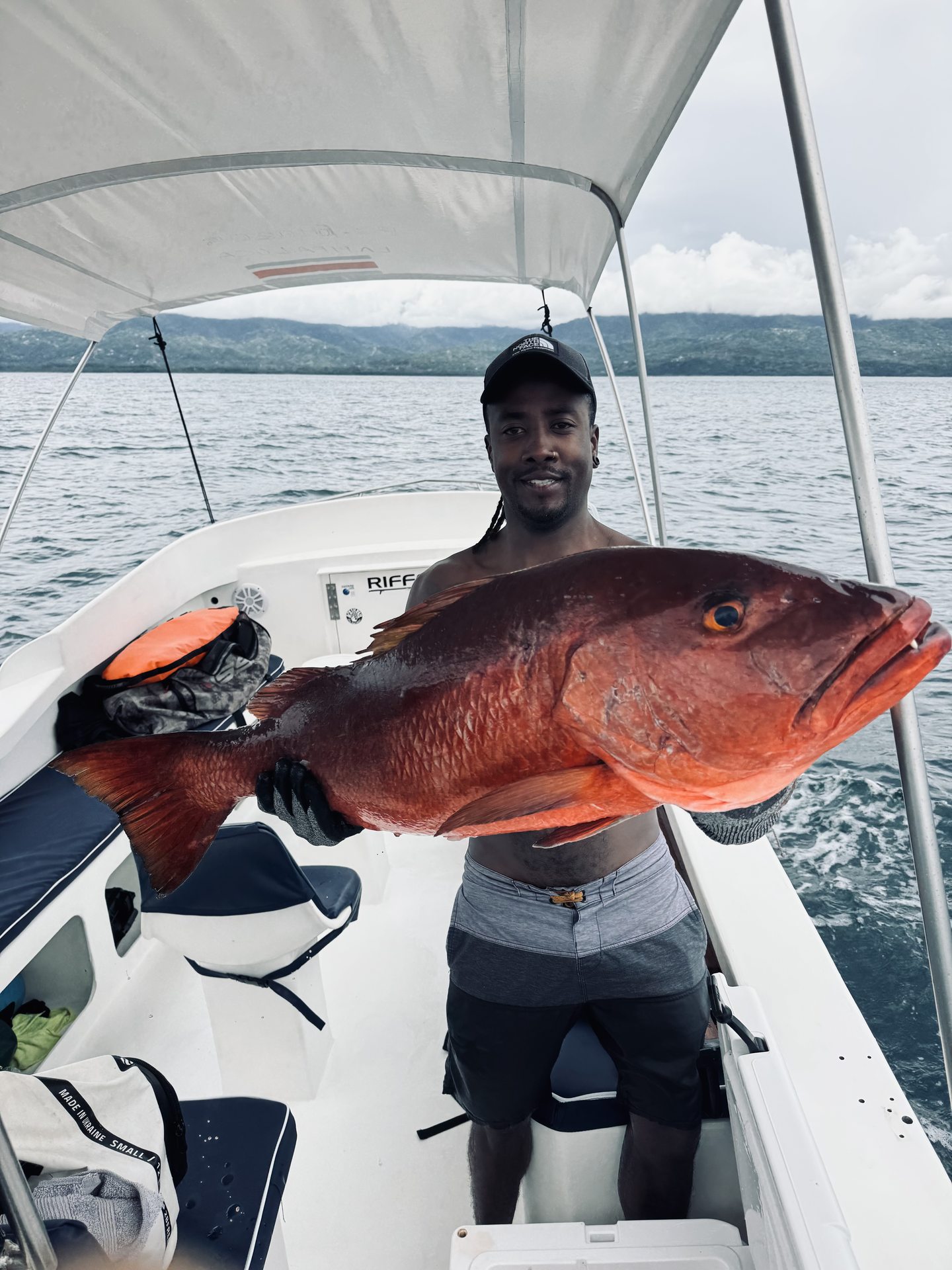 A guest with a snapper on the boat