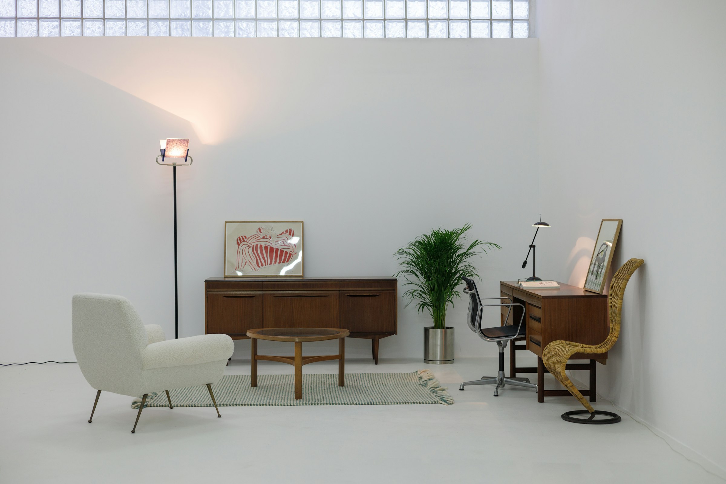 Mid-century modern room with a white chair and sideboard