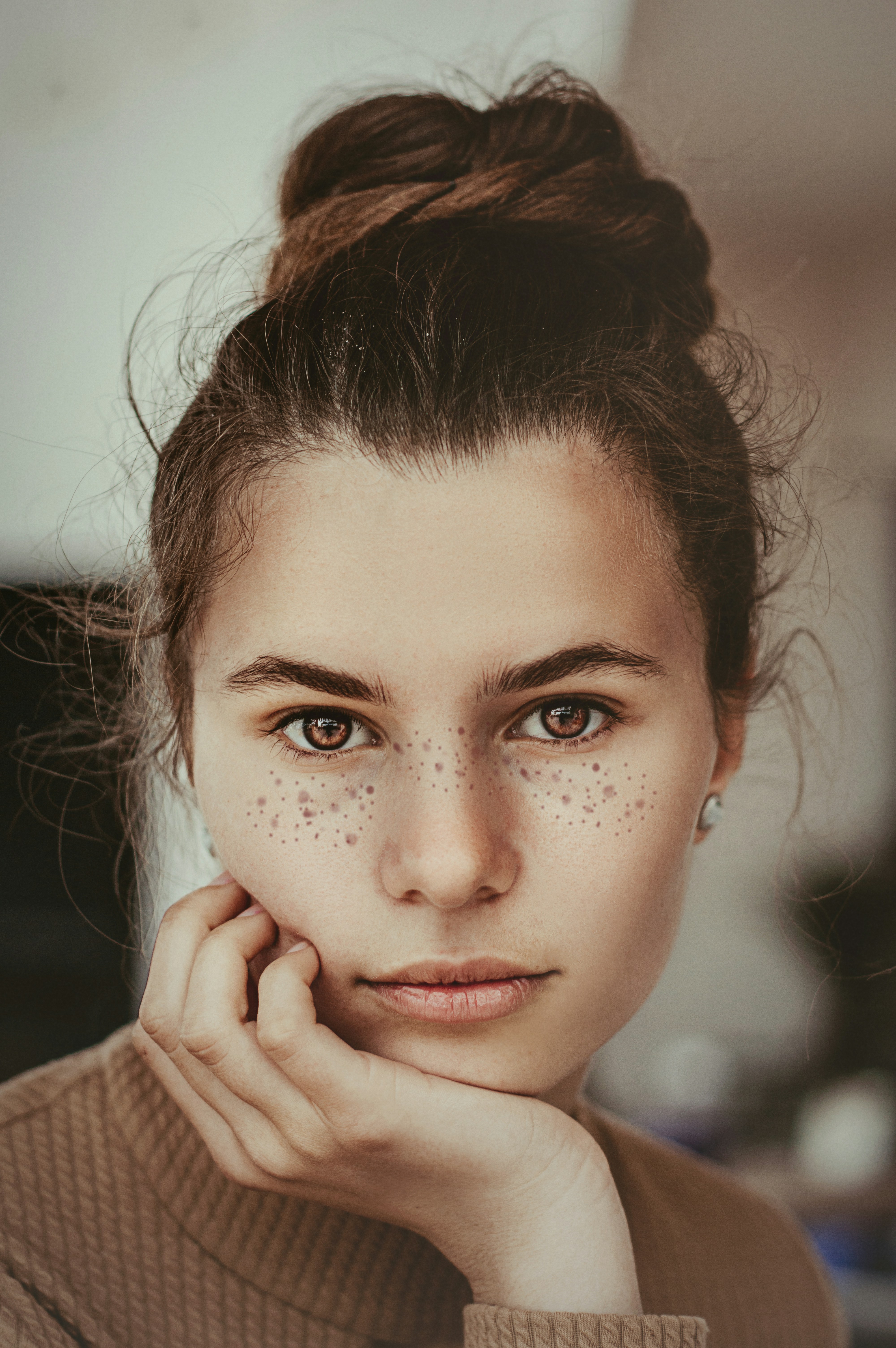 Close-up portrait of a woman with bare, freckled skin