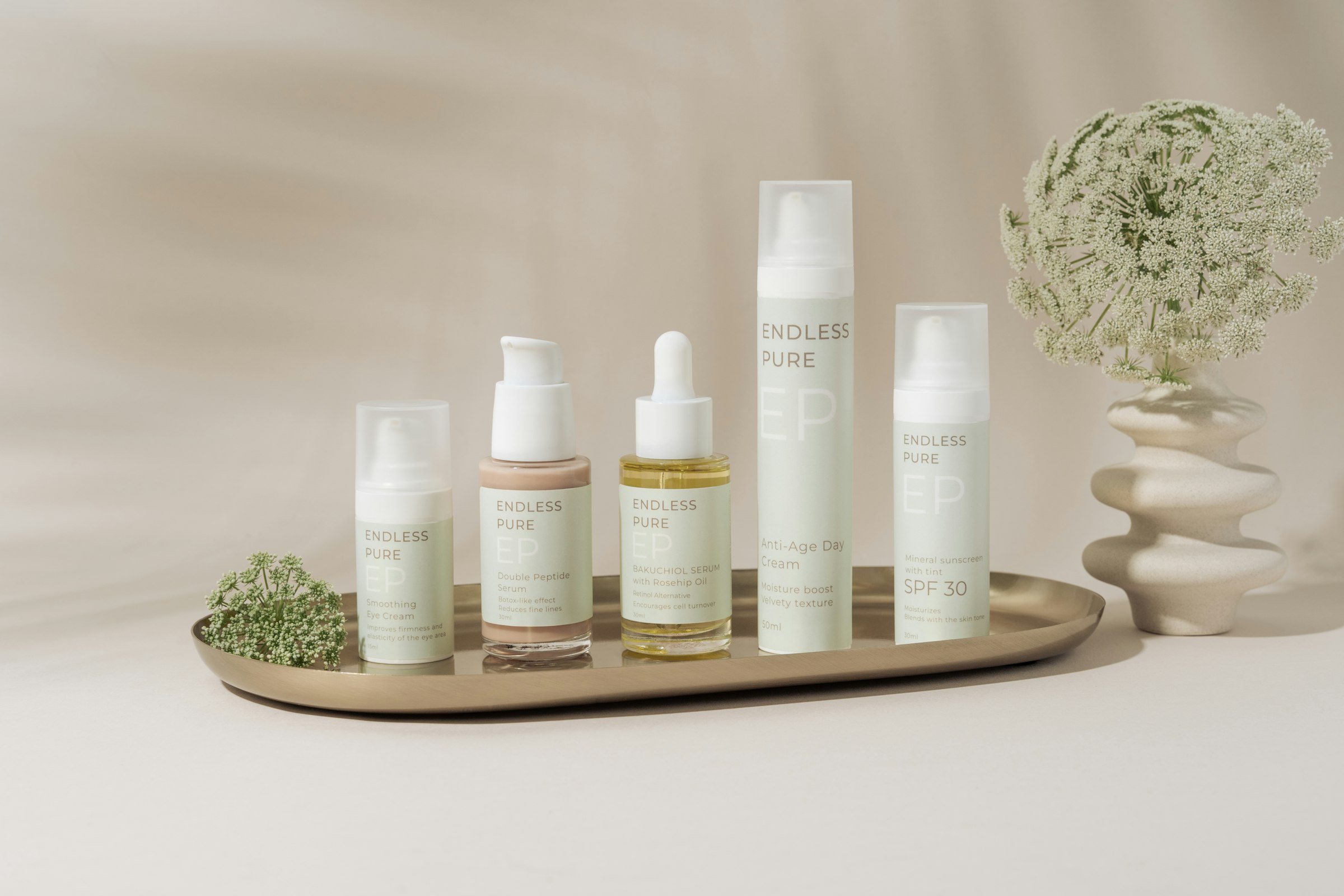 A tray of unbranded skincare bottles in soft daylight
