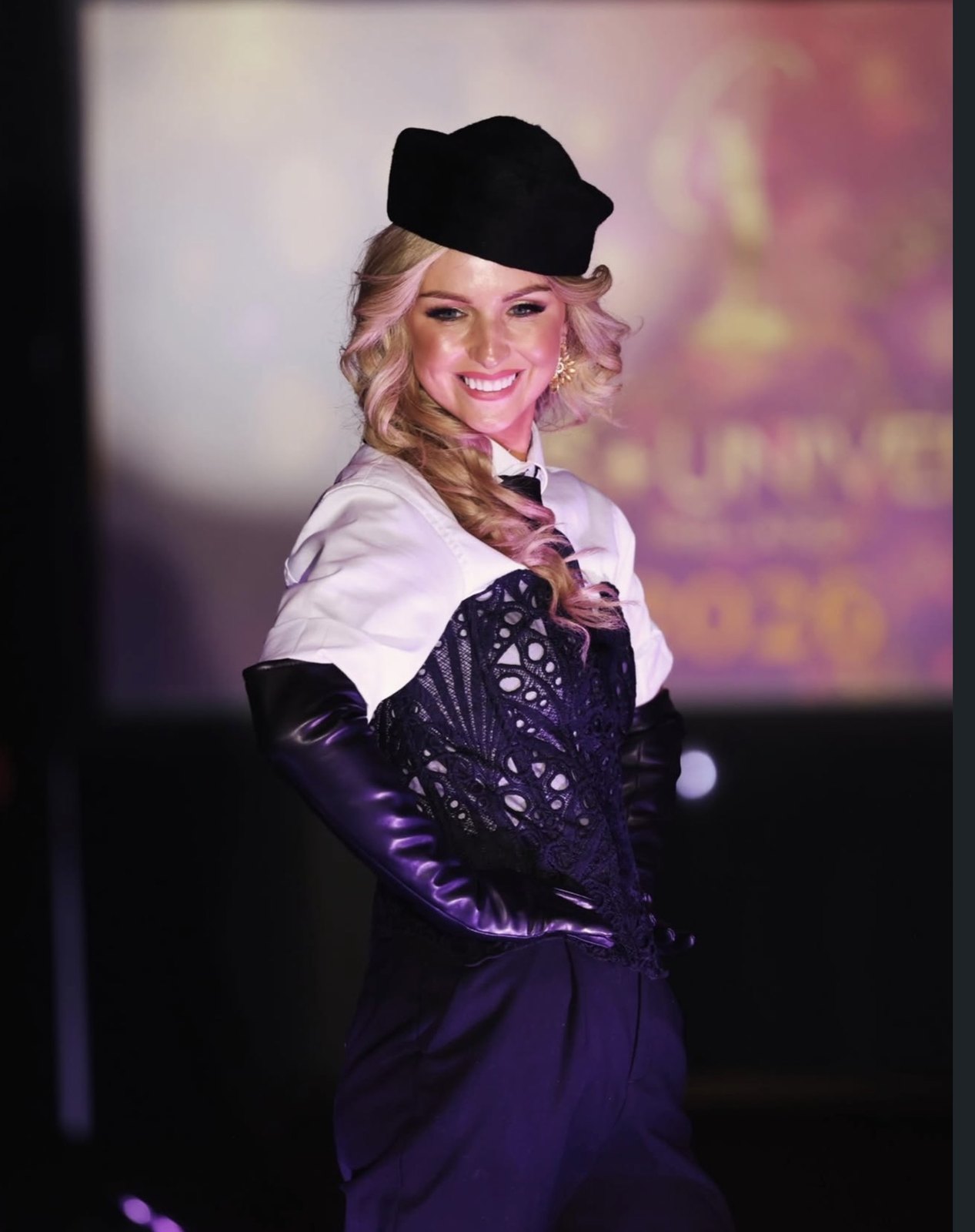 Davinia Knight on the Miss Universe Ireland stage in a black beret and lace corset