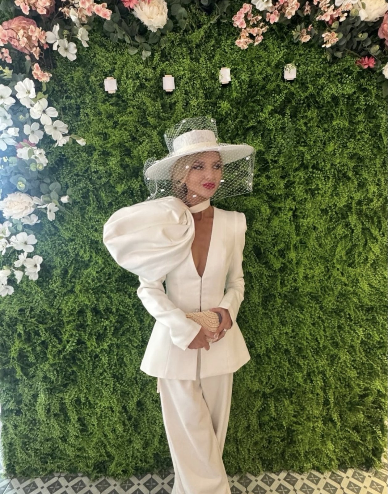 Cleo Knight, Ms Offaly, in an ivory trouser suit and a veiled wide-brimmed hat