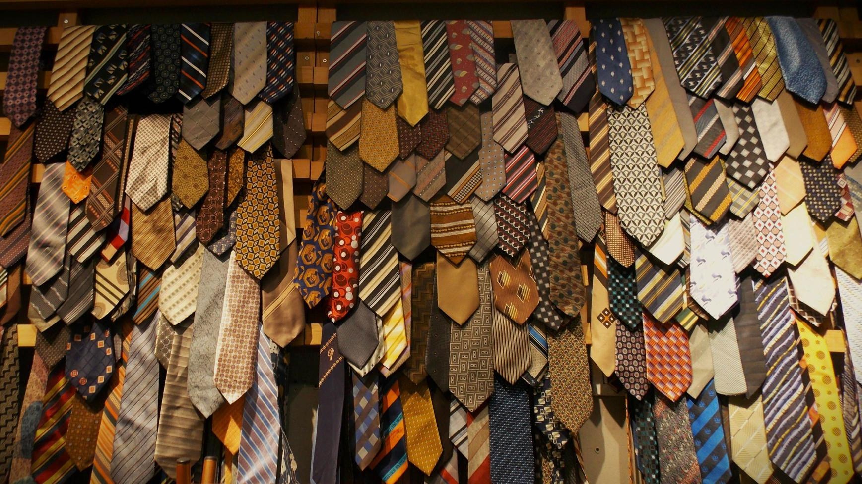 A wall densely covered with hundreds of patterned neckties