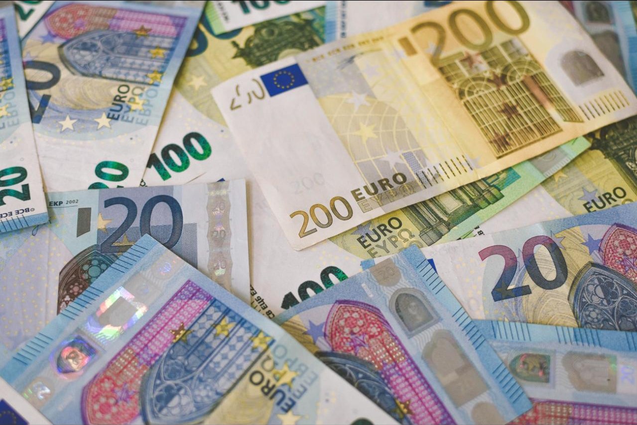 A scattered pile of euro banknotes in various denominations