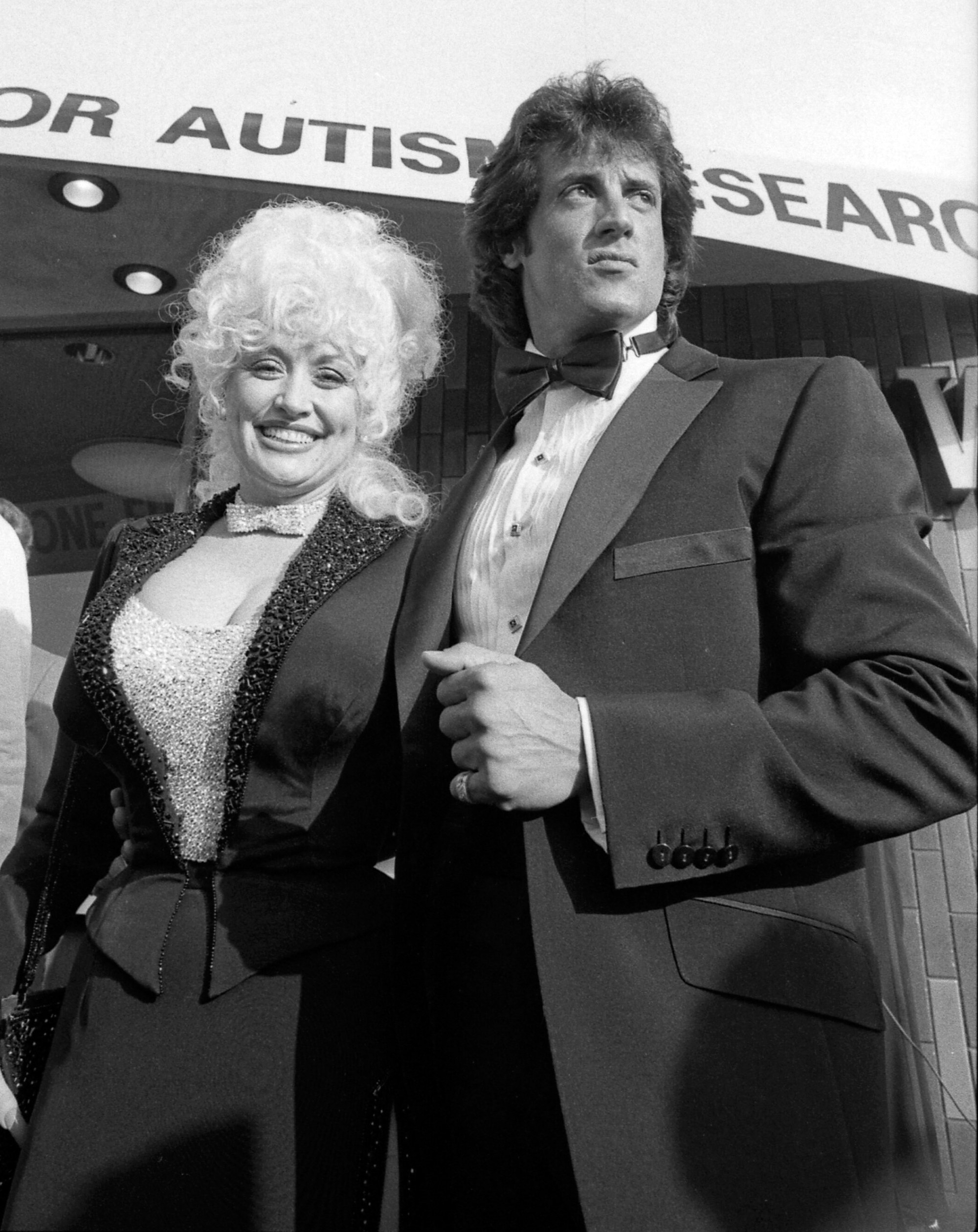 Dolly Parton and Sylvester Stallone at a 1984 charity premiere of their film Rhinestone in Los Angeles.