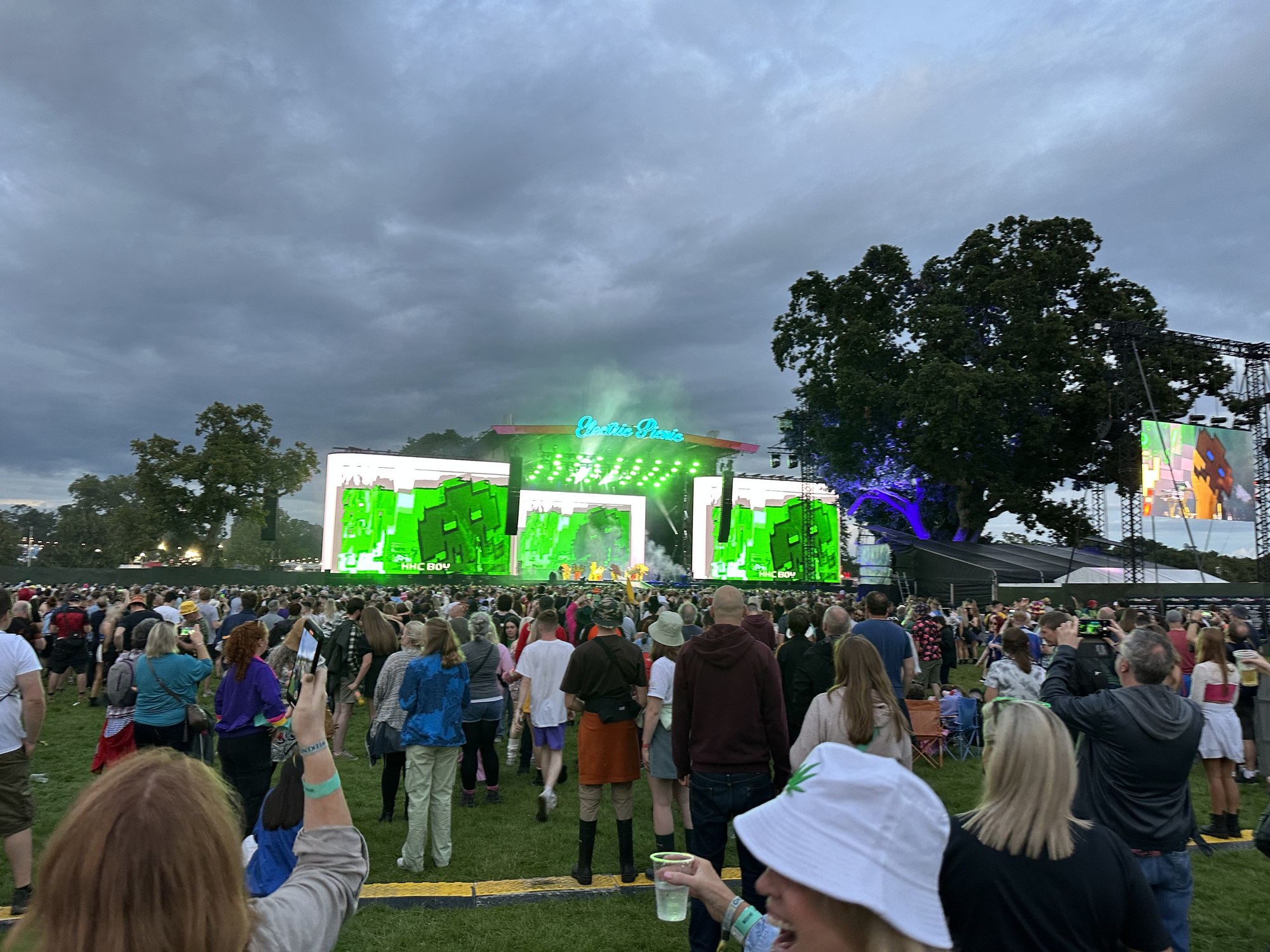 A daytime crowd in front of a stage at Electric Picnic under grey cloud.