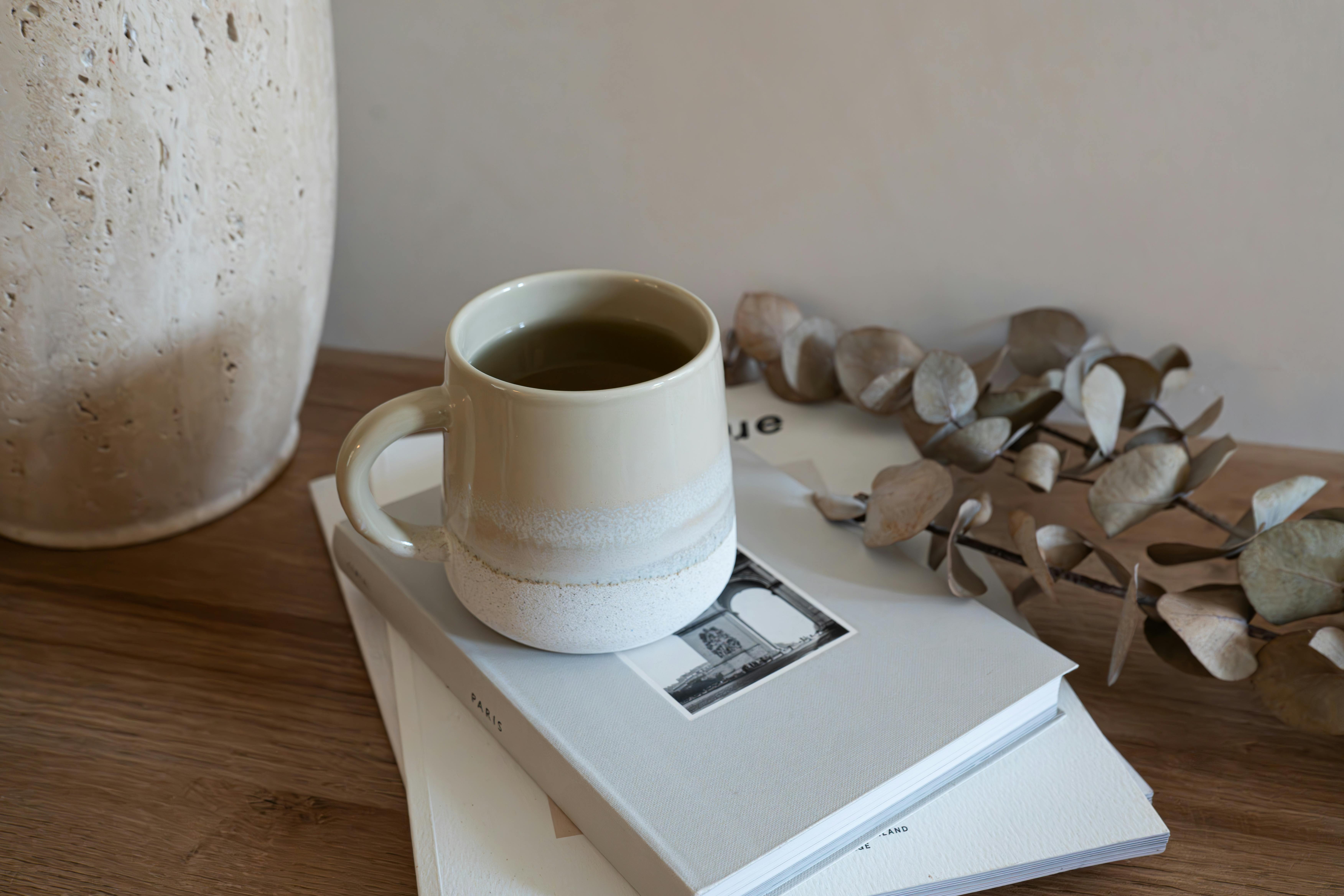 Coffee mug with books decor stock image